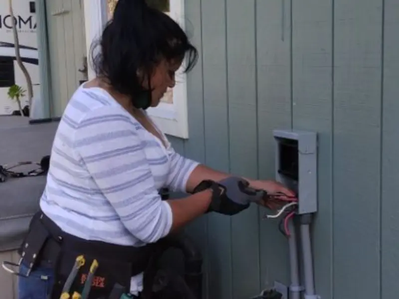 Licensed electrician wiring an exterior subpanel in Giddings