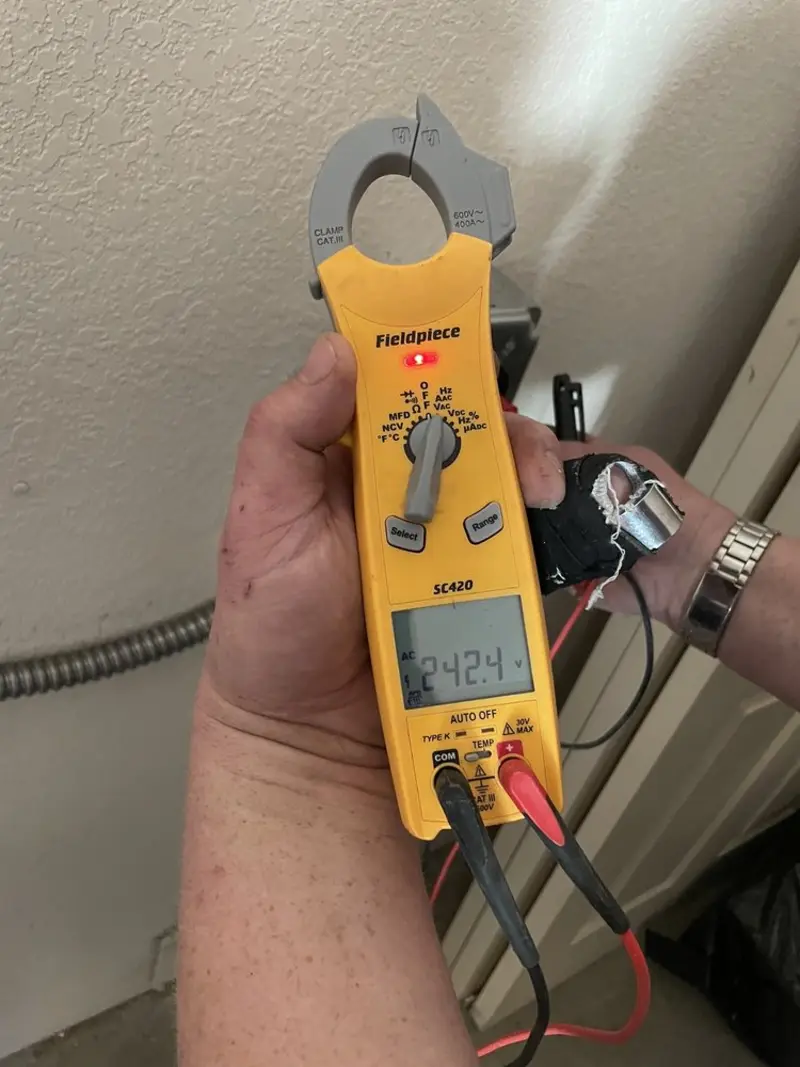 Voltage testing with clamp meter during Ceiling Fan Installation in Giddings